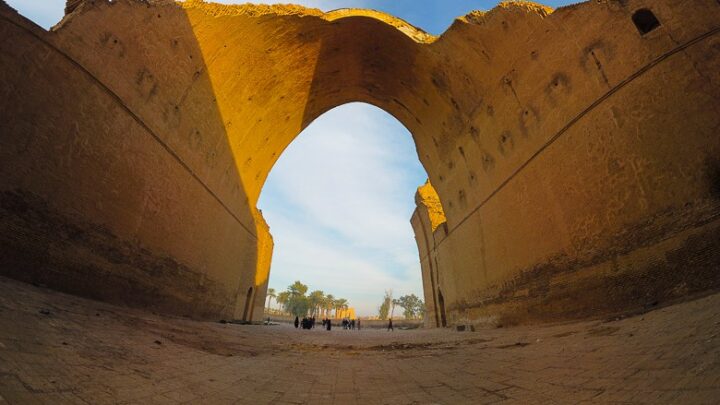 standing under the arch of Taq Kasra in Iraq