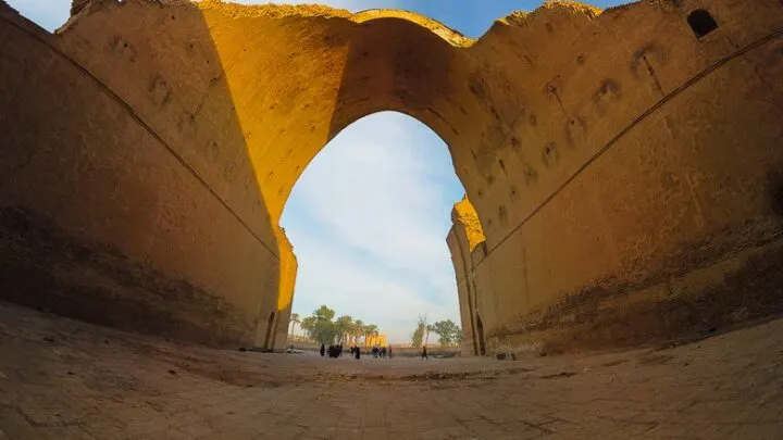 standing under the arch of Taq Kasra in Iraq